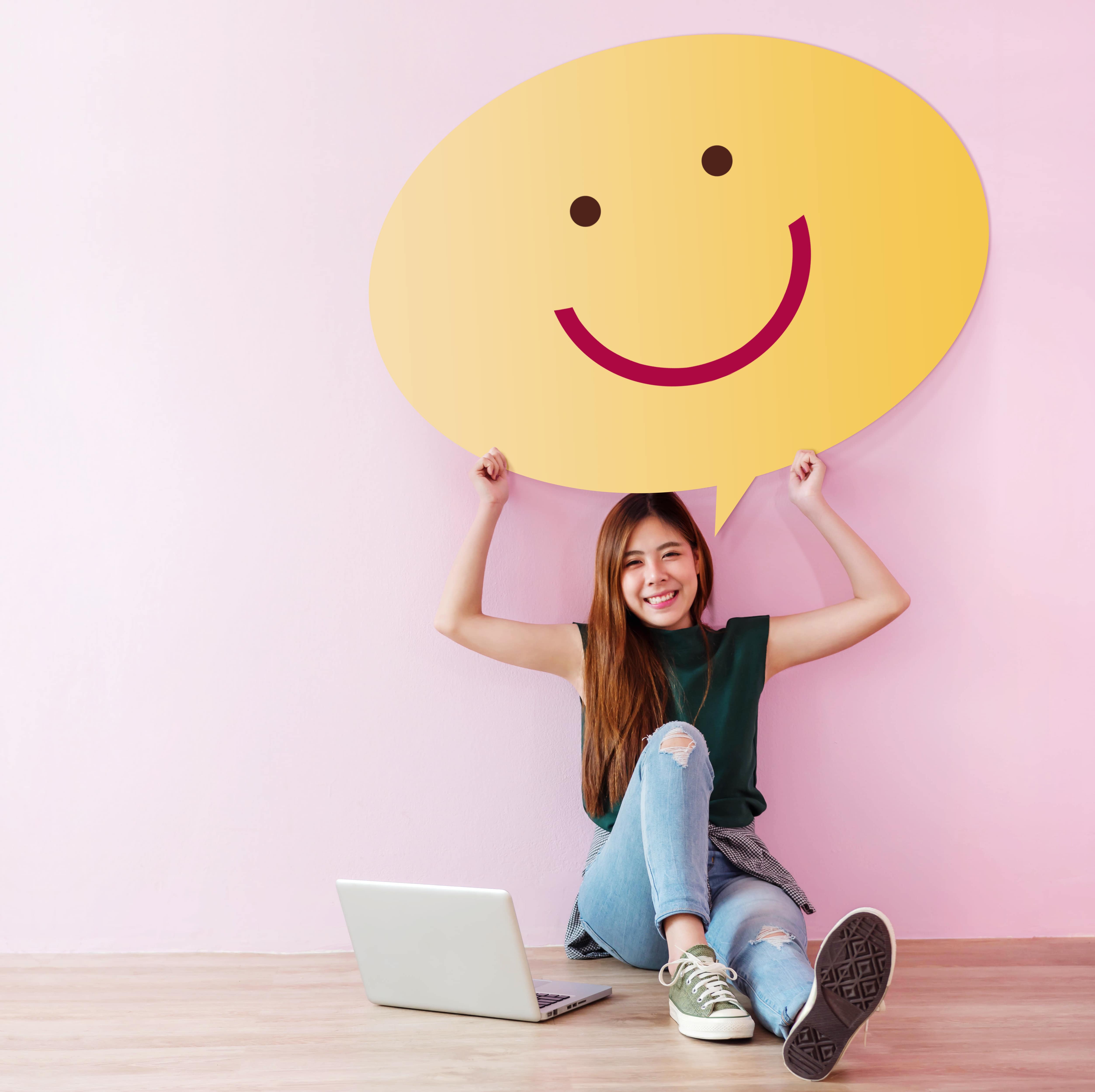 happy woman holding up smile blurb