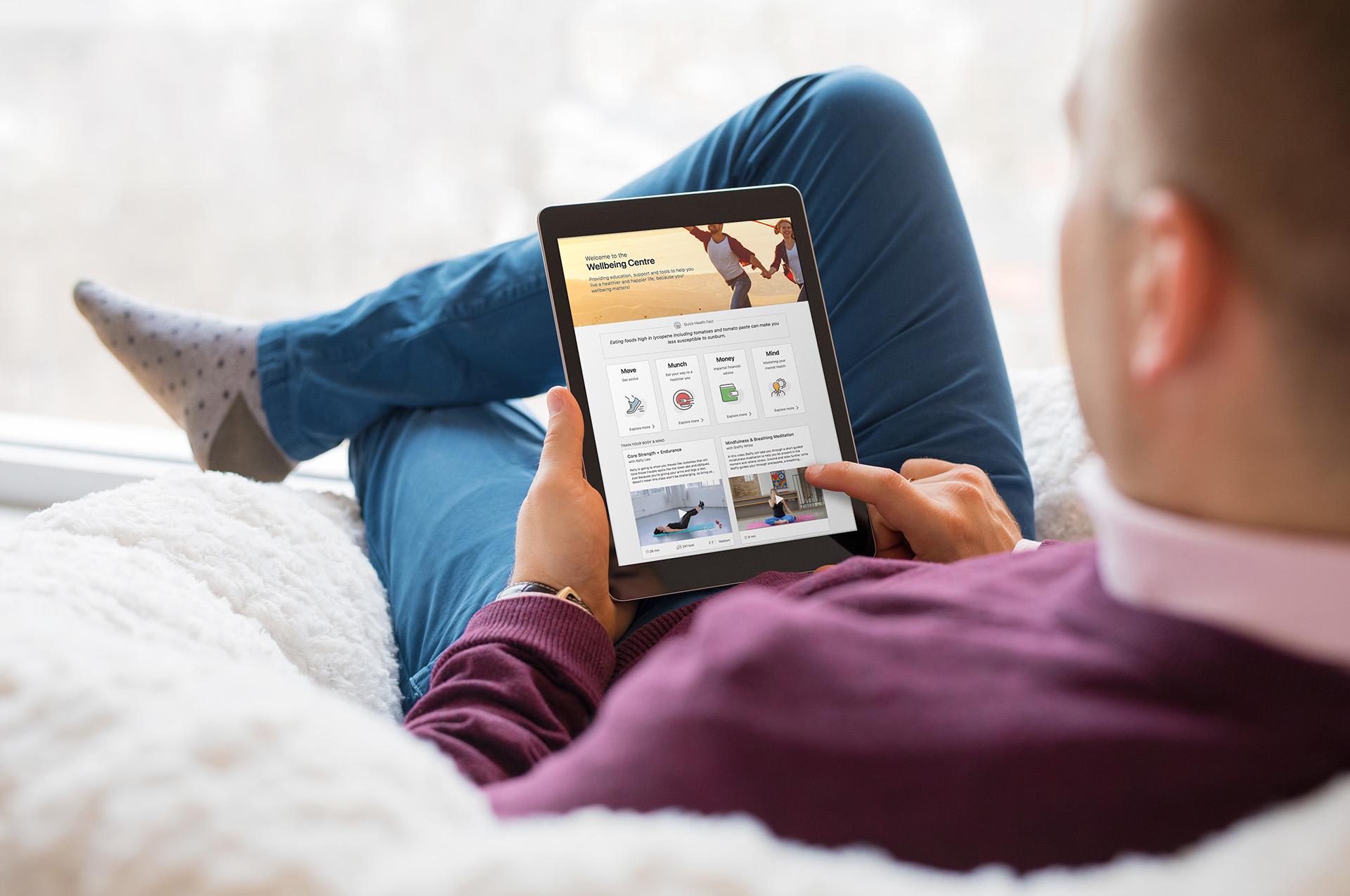 Employee looking at Wellbeing Centre on an iPad