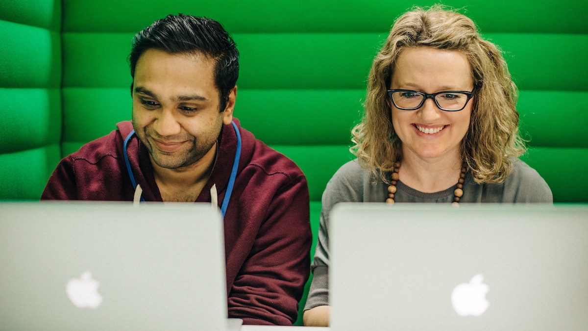 Ren Patel and Megan Gough sitting at green table - Employee Engagement Lessons this St Patrick's Day